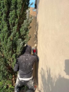 Personne plâtrant un mur extérieur au soleil